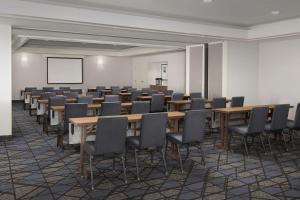a conference room with tables and chairs and a whiteboard at Courtyard by Marriott Dothan in Dothan