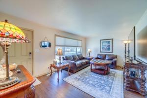 a living room with a couch and a table at Family-Friendly Sand Springs Home about 8 Mi to Tulsa! in Sand Springs