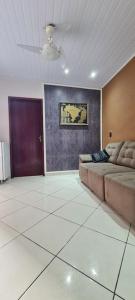 a living room with a couch and a ceiling at Rose House in Arraial do Cabo