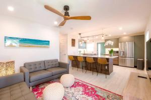 a living room and kitchen with a couch and a table at TOP RATED! Namaste Here steps to Flagler & Beach in New Smyrna Beach