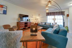a living room with blue couches and a table at Chic Lexington Home with Deck about 5 Mi to Downtown! in Lexington
