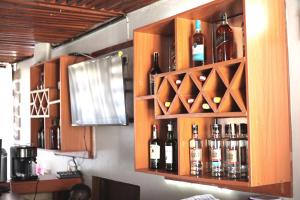 a cabinet filled with bottles of wine on a wall at Orchid Suites, Kira in Bulindo