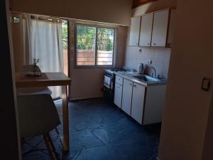 a small kitchen with a sink and a stove at CHE LOLITA HOUSE 3 in El Palomar