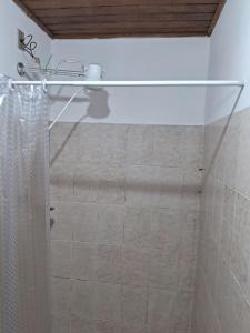 y baño con ducha y cortina de ducha. en Chalé do riacho 2 en Penedo