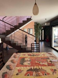 a living room with a staircase and a rug at Villa Bellevue in Ouoran +94 photos