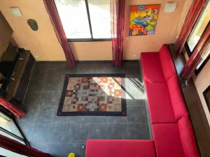 an overhead view of a living room with a red couch at Villa Bellevue in Ouoran