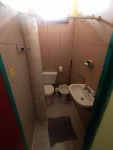 a small bathroom with a toilet and a sink at CABAÑAS LDM in San Isidro