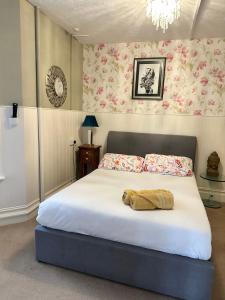 a bedroom with a large white bed with flowers at The Boho - 4 min walk to beach & town in Bournemouth