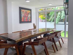 a dining room with a wooden table and chairs at Casa en Quintas del Mar con acceso a la playa in Mazatlán