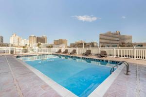 a swimming pool with a city skyline in the background at Best Western Corpus Christi in Corpus Christi