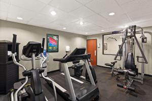 a gym with several tread machines in a room at Best Western Galleria Inn & Suites in Houston