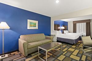 a hotel room with a couch and a bed at Best Western Galleria Inn & Suites in Houston +19 photos