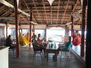 a group of people sitting at a table in a restaurant at Lighthouse Bungalows in Haad Rin