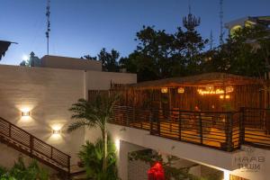 a building with a balcony with lights on it at Kaab Tulum in Tulum