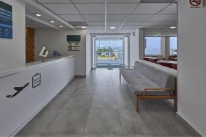 a waiting room with a bench in a building at City Express Junior by Marriott Guadalajara Periferico Sur in Guadalajara