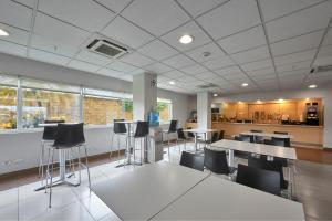 an office with tables and chairs and a kitchen at City Express by Marriott Minatitlán in Minatitlán