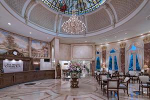 a lobby with a chandelier and tables and chairs at The Westin Camino Real, Guatemala in Guatemala