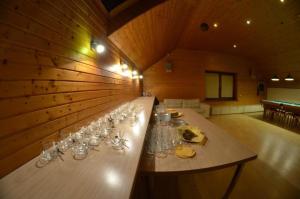 a long table with wine glasses in a room at Pakavciems pirts in Riga