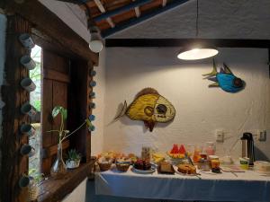 a table with food on it in a room at Pousada Bangalôs Cipó in Serra do Cipo