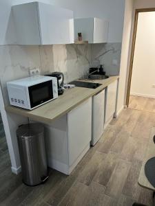 a kitchen with a counter with a microwave on it at NICEHOME MASSENA in Nice