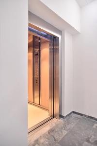 an elevator in a building with a glass door at Erato Hotel in Agia Marina Aegina