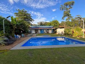 a swimming pool in the yard of a house at Hotel Sueños de María in Uvita