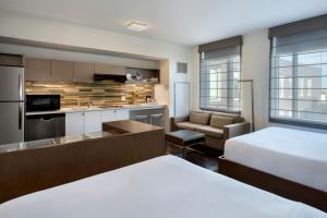 a hotel room with a bed and a kitchen at Element Boston Seaport District in Boston