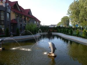 a statue of a dolphin in a pond at Motel DHS - Chinese Restaurant in Deva