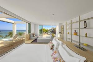 a living room with a view of the ocean at W Ibiza in Santa Eularia des Riu