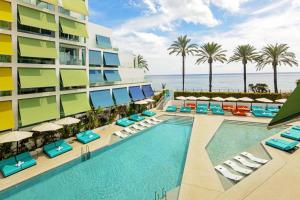 an image of a resort with a swimming pool and chairs at W Ibiza in Santa Eularia des Riu