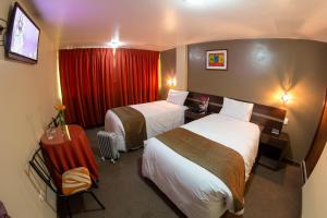 En eller flere senge i et værelse på UTASA VILLAREAL Inn