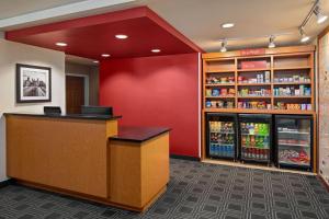 a bar in a store with a red wall at TownePlace Suites by Marriott Minneapolis Downtown/North Loop in Minneapolis