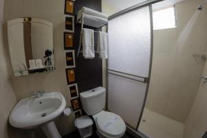 een badkamer met een toilet, een wastafel en een douche bij UTASA VILLAREAL Inn in Puno