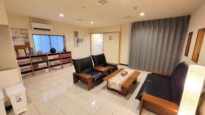 a living room with two chairs and a coffee table at CHEZ LILY【旧:北海莊】 in Naha