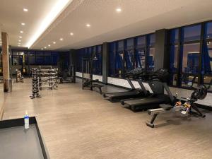 a gym with treadmills and machines in a building at Studio Books Id Vida Urbana in Goiânia