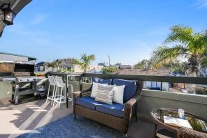 a patio with a chair and a table on a balcony at Stunning South Mission Beach Home - AC, Private Patio, Grill and Garage! in San Diego