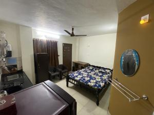 a bedroom with a bed and a living room at Charming guesthouse in heart of Manipal in Manipala