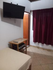 A television and/or entertainment centre at FLOWERs HOSTEL