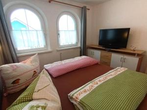 a small room with two beds and two windows at Nice holiday home in Hochgallmigg with terrace in Hochgallmig