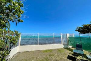 a balcony with a view of the ocean at Blackstone Paea Premium beachfront bungalow private access wifi - 3 pers in Paea