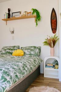 a bedroom with a bed with a green and white comforter at Surf Shack in Iconic Rainbow Bay - Coolangatta QLD (pet friendly) in Gold Coast