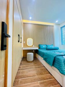 a bedroom with a bed and a desk at Ocean Villa Novaworld Phan Thiết in Bình Tú