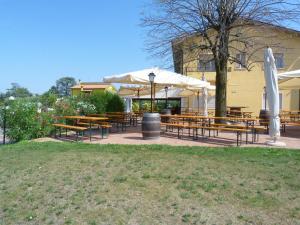 a group of tables and umbrellas in front of a building at Le Colline del Garda in Bussolengo