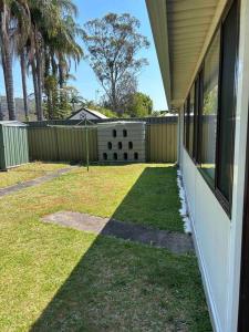 a yard with a house with a backyard with a fence at Specious Studio W Gosford Centre in Gosford