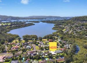 an aerial view of a suburb with a sign that reads here at Specious Studio W Gosford Centre in Gosford