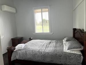 1 dormitorio con cama y ventana en Country charm on acreage, en Kingaroy