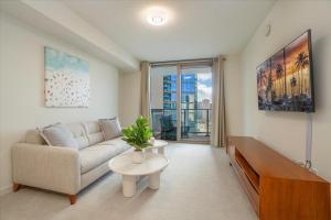 a living room with a couch and a table at Sky Ala Moana 2307 condo in Honolulu