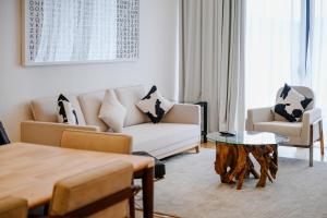 a living room with a couch and a table at The RIYAZ Lavanya in Pantai Cenang