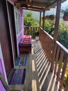 a porch with a bench on a house at Hillsation Thulung Homestay in Kalimpong