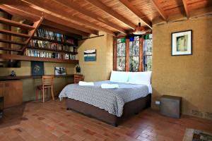 a bedroom with a bed and a book shelf at Corymbia in Broke